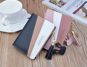 Detail view of women short color block wallet with zipper tassel and cute bunny charm.