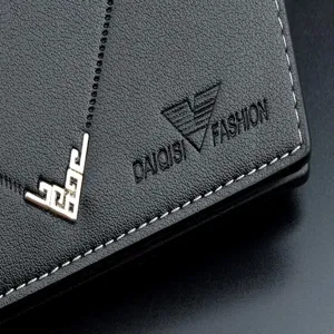 Men's black leather wallet detail, showing fine stitching, metal corner, and embossed logo.