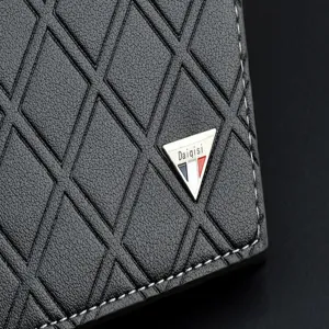 Close-up detail of men's black quilted wallet with soft leather and metal logo accent.