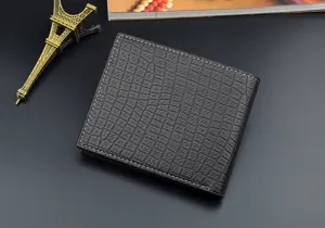Men's dark brown crocodile pattern short wallet detailed view showcasing texture and stitching.
