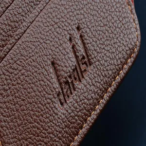 Vue de détail rapprochée de la surface du portefeuille en cuir grainé de qualité supérieure avec logo.