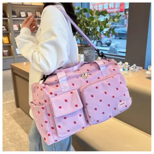 Pink corduroy strawberry travel duffel bag with multiple pockets and large capacity for daily use.