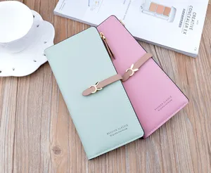 Detail view of long women wallets in mint green and pink with cute bunny buckle and slots.