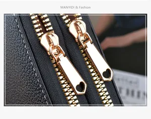 Black PU leather long wallet detail shot featuring gold-plated dual zippers with heart pulls.
