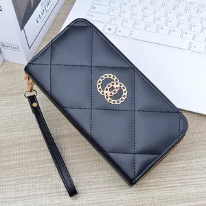 Women black quilted long wallet with wrist strap and gold ring decor, elegant double zipper design.