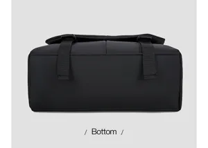 Detail view of the black waterproof oxford cloth messenger bag bottom with sturdy buckles.