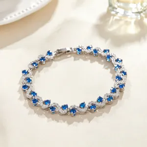Elegant cross-inlaid blue zirconia bracelet detail view, sparkling gemstone women fashion jewelry.