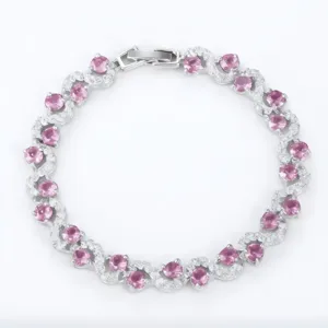 Close-up view of the intricate S-curve silver bracelet featuring sparkling pink zircons.