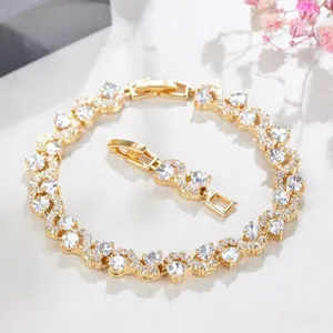Gold tone rhinestone S-curve bracelet close-up view showing sparkling cubic zirconia.
