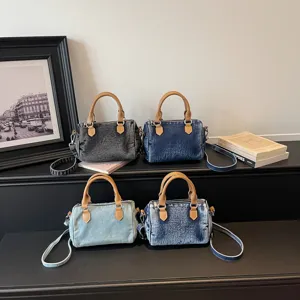 Retro washed denim boston bag for women, casual commuter handbag with shoulder strap.