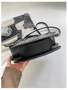 Black punk style crossbody handbag for women with silver studs, unique design street fashion bag.