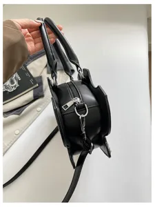 Gothic black PU leather shoulder bag with unique bat wing design and metal hardware detail.