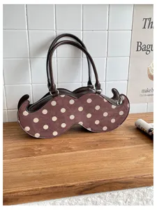Quirky polka dot handbag for women, unique mustache shaped design, stylish commuter shoulder bag.