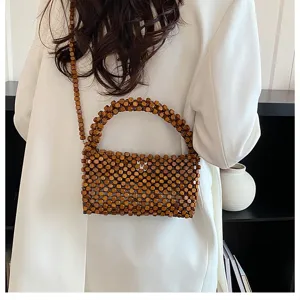 Chic borsa a tracolla in perline di legno da donna, elegante borsa da spiaggia cava con cinturino.