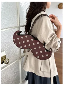 Chic polka dot irregular underarm bag, unique niche design shoulder bag for modern women commuting.