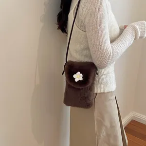 Cute plush mini crossbody bag for women, furry phone bag with chic white flower accent.