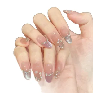 Handcrafted press-on nails with pink gradient cat eye and lily of the valley rhinestones.