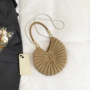 Woven conch shell beach handbag for women, fashion pearl strap underarm crossbody bag main view.