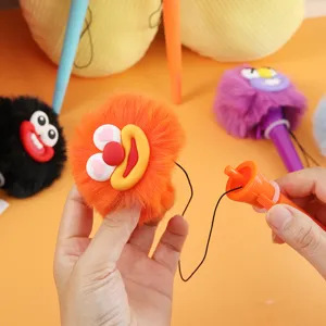 Close-up of funny fuzzy monster gel pen detail, playful fluffy design with pull string feature.