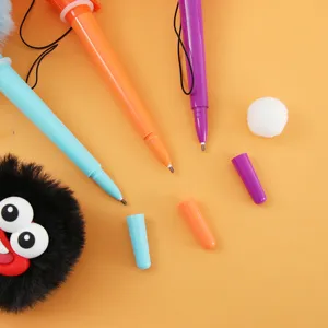 Close-up detail of cute funny big mouth monster gel pens with colorful bodies and caps.