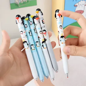 Close-up detail of cute penguin retractable gel pens with smooth black ink writing.