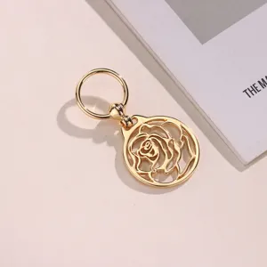Detail shot of the golden hollow rose scarf buckle and stylish metal bag charm pendant.