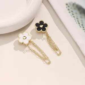 Metal flower magnetic pant cuff cinches with chain details for length adjustment detail