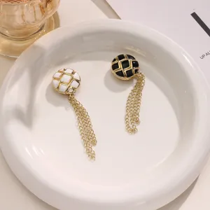 Close-up of stylish magnetic pants hem tightening clips featuring delicate chains for fashion.