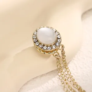 Fashion rhinestone cat eye stone magnetic buckle brooch multiuse clothing accessory detail.