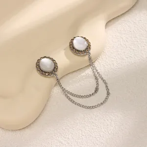 Close-up detail of the magnetic clothing pin with double chain and cat's eye stone accent.