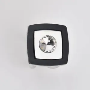 Square scarf buckle detail showing black border and central crystal accent accessory.