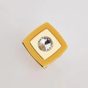 Close-up of square yellow acrylic scarf buckle with gold metal and center rhinestone.
