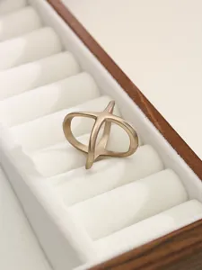 Matte gold X-shaped metal scarf buckle and clothing accessory detailed showcase view