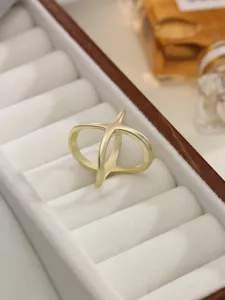 Matte gold X-shaped fashion ring and versatile silk scarf buckle for elegant daily wear.