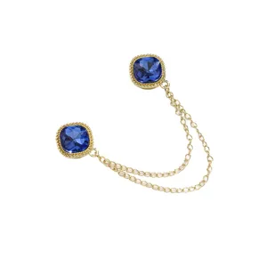 Magnetischer Ärmelhalter und Hosenklammer mit goldenen Ketten und blauen Strasssteinen.