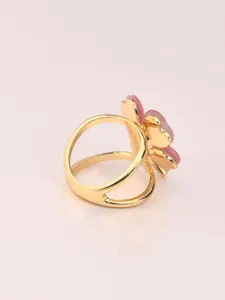 Gold plated metal pink four leaf clover ring detail closeup shot elegant jewelry piece