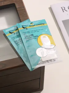 Detail close-up of hijab double-sided tape packaging, showing clear instructions and texture.