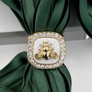 Close-up view of the luxury vintage square bee silk scarf ring buckle with sparkling rhinestones.