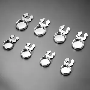 Close up detail of 8 silver metal button covers, stylish round shirt button caps, polished finish.