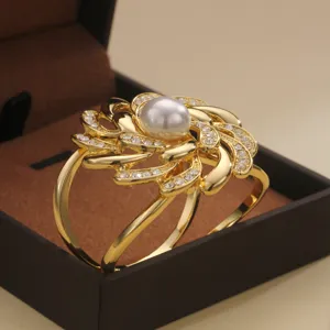 Elegant gold camellia scarf buckle with pearl and rhinestones, versatile clothing brooch accessory.