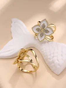 Close-up detail of luxury four-leaf clover scarf ring featuring sparkling rhinestones and enamel.