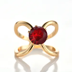 Elegant gold-tone bow scarf ring with a stunning red crystal centerpiece for women.