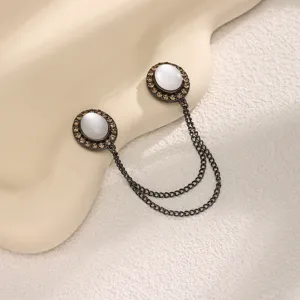 Elegant magnetic brooch clips with cat's eye stones and double chains for women fashion apparel.