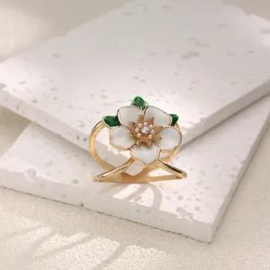 Gardenia flower scarf buckle detail, gold metal with white enamel and sparkling rhinestones.