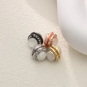 Close-up view of elegant rhinestone hijab magnetic pins featuring cat-eye stone details.