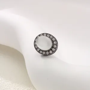 Close-up detail of an oval magnetic hijab pin featuring sparkling rhinestones and cat eye.
