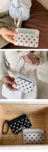 Patent leather polka dot cardholder detail view showing card slots and zipper pocket.
