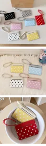 Detailed view of the colorful patent leather polka dot card case detail and display.