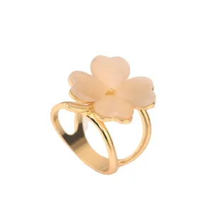 Gold-plated four-leaf clover ring with pink cat eye stone, sweet and elegant fashion accessory.