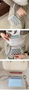 Patent leather polka dot card holder mini wallet with wrist strap and zipper coin pocket detail.